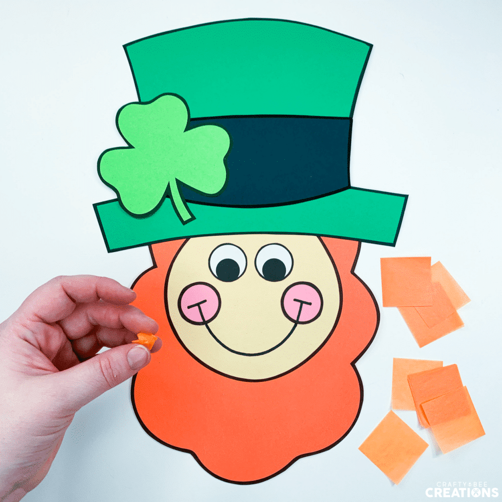 Step two of the leprechaun craft is to roll the tissue paper into balls.