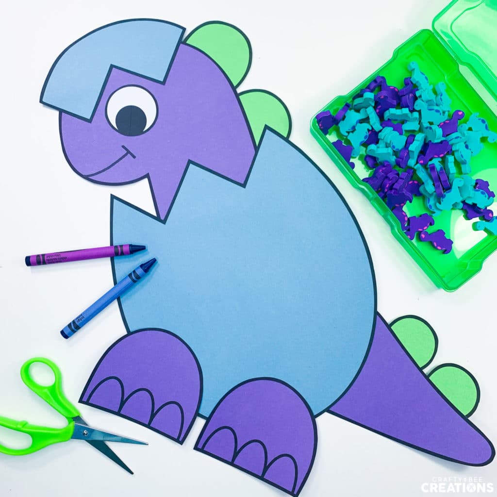 Baby dinosaur craft with crayons, scissors and mini erasers.
