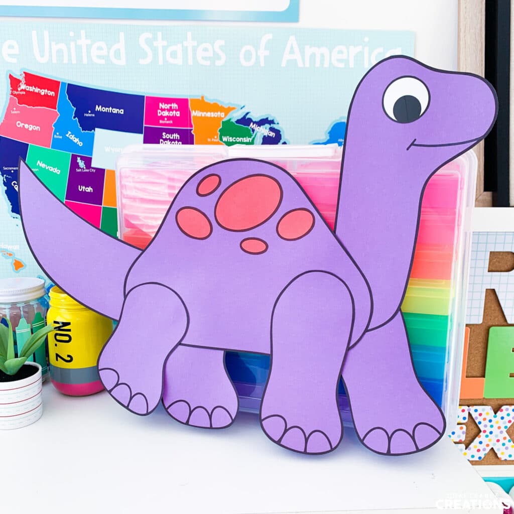 Brontosaurus craft leaning against colorful drawers.