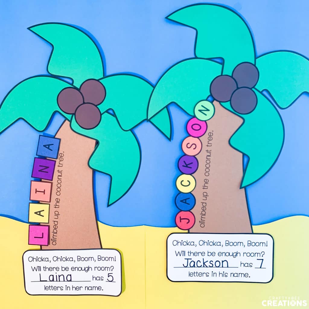 Two coconut name tree crafts hanging on a blue and tan background to look like a beach scene.