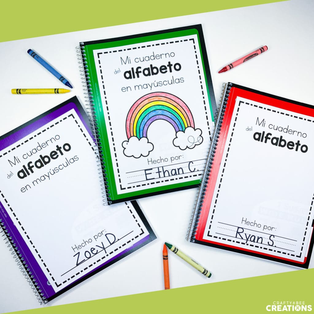 Three spiral bound Spanish Alphabet Interactive Notebooks with cover pages and customized students names.