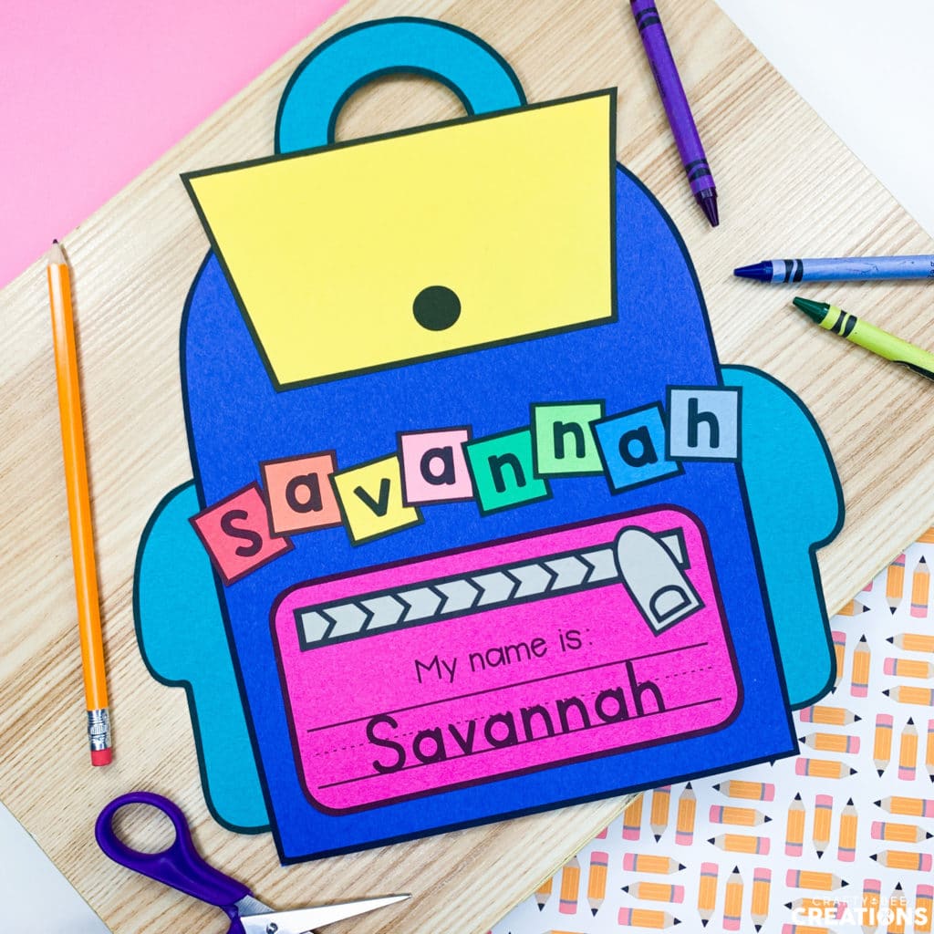 The backpack name writing craft is the perfect back to school activity for any grade level. The craft is pictured with crayons and scissors here.