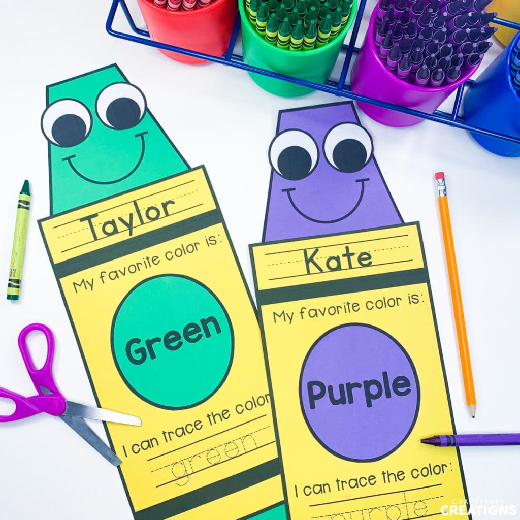 The crayon name writing craft is pictured with crayons in purple and green.