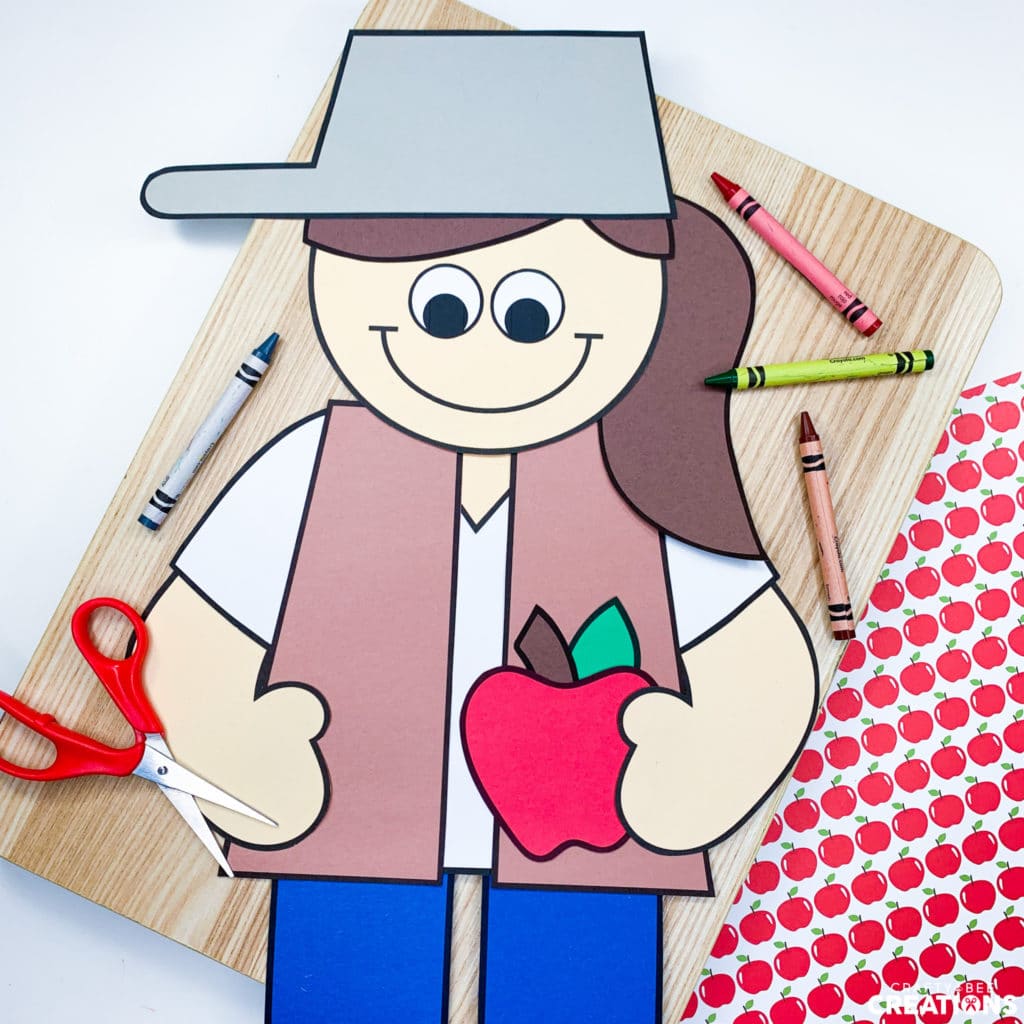 Johnny Appleseed craft with red apple butcher paper and scissors.