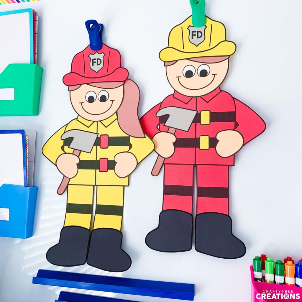 Firefighter crafts hanging up on a whiteboard by clips.