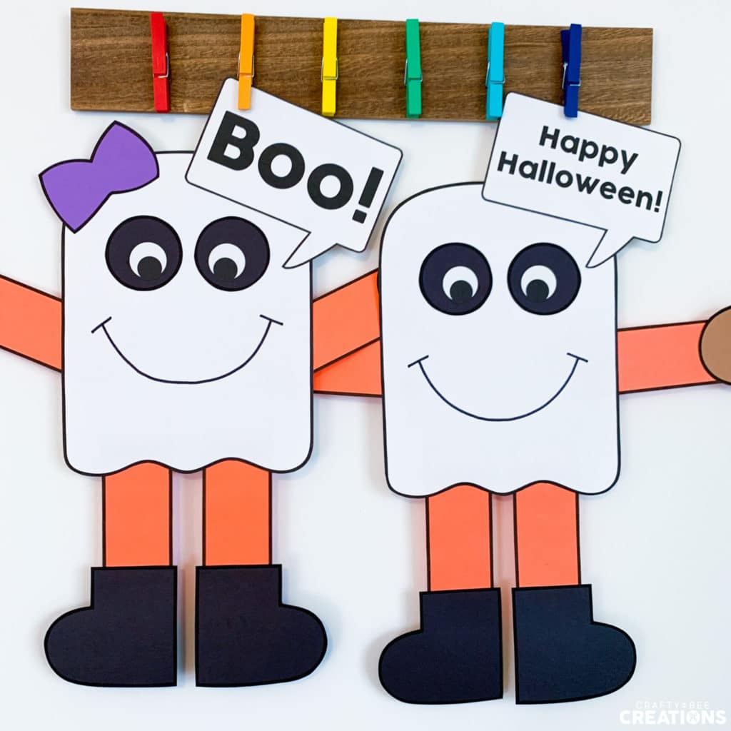 Free Ghost Crafts completed on colored cardstock. They are saying "boo" and "Happy Halloween".