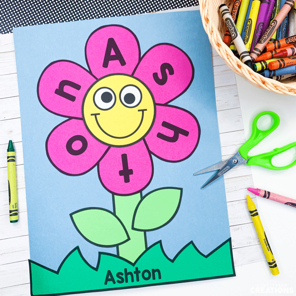 Adorable pink flower name craft completed by a child.